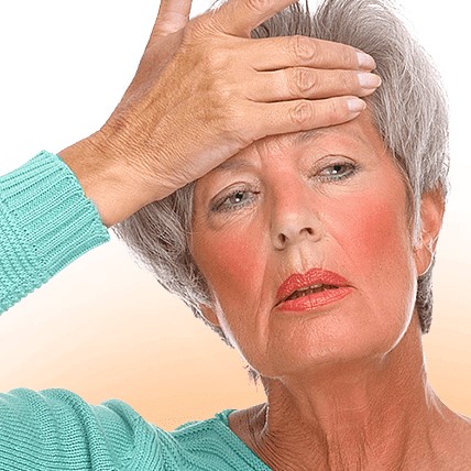 Woman experiencing flushed cheeks due to hormonal changes during menopause